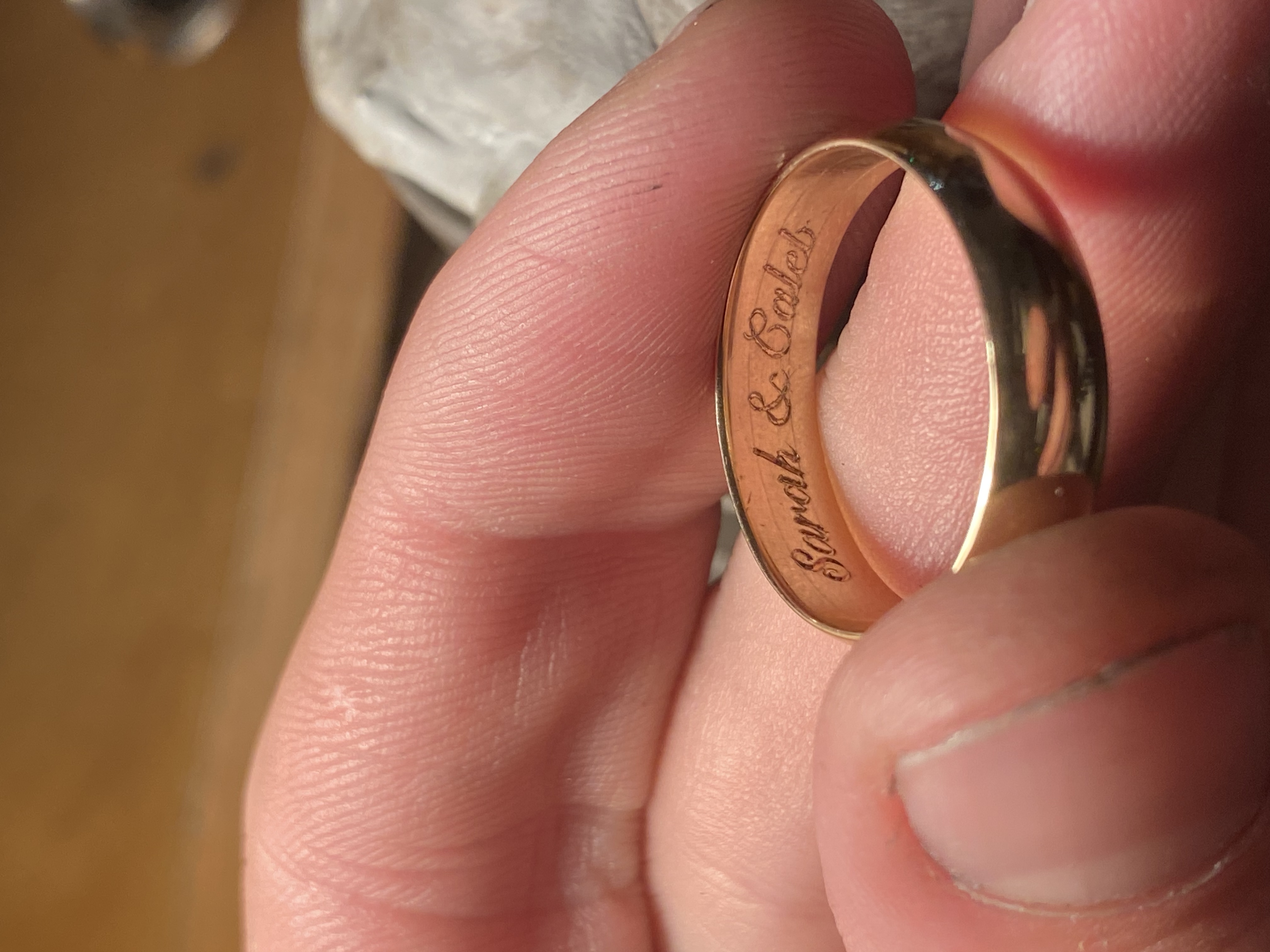 Inside ring inscription Sarah and Caleb hand-engraved in gold wedding band — custom engraving Toronto