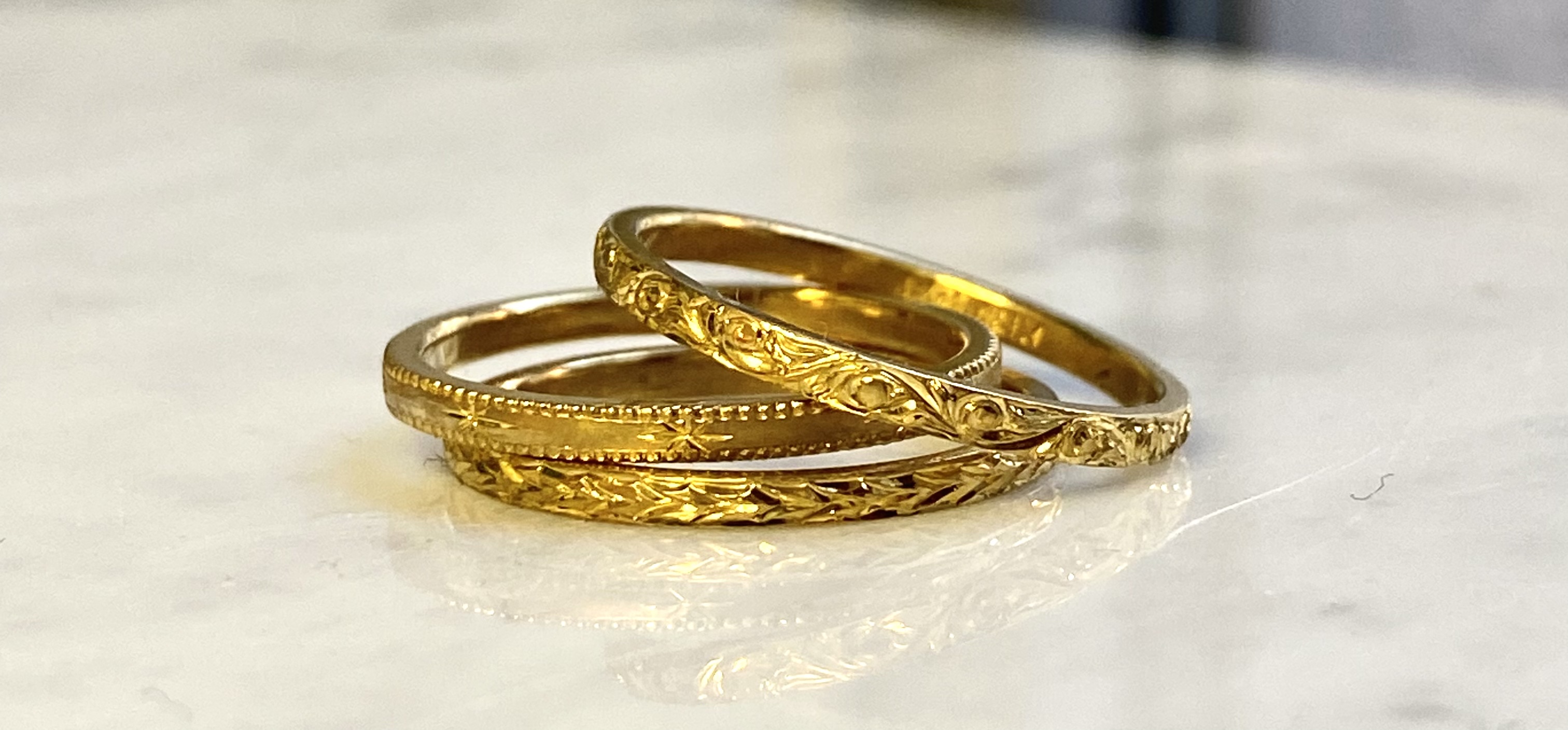 24 karat gold hand-engraved stacking ring trio floral scrollwork milgrain and wheat laurel — Bear Goldsmithing Toronto