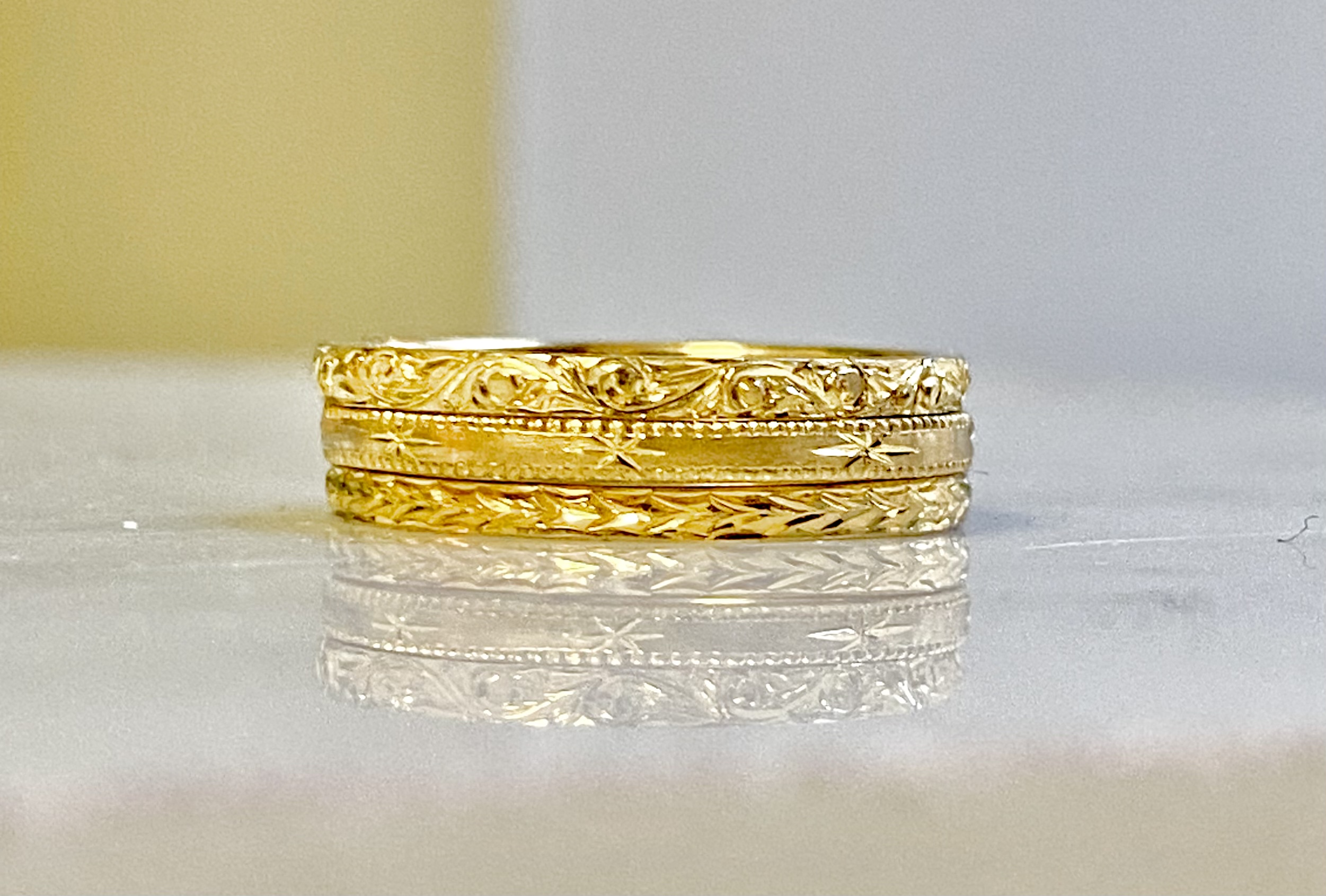 24 karat gold hand-engraved stacking trio stacked face-on — Bear Goldsmithing Toronto