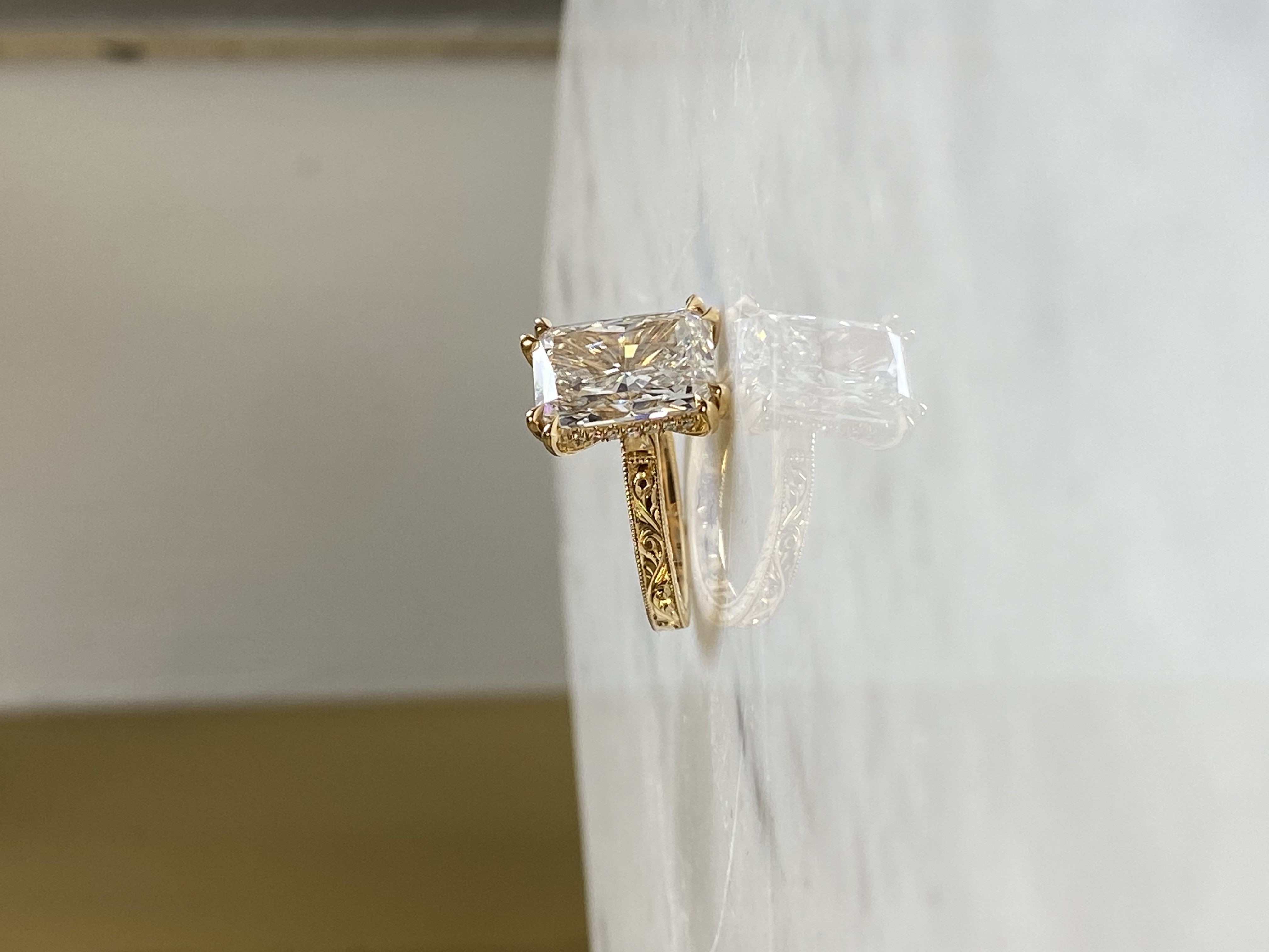 5ct emerald cut diamond double claw set hidden halo three sides scrollwork engraving hidden gems inside band 18k yellow gold — Bear Goldsmithing Toronto