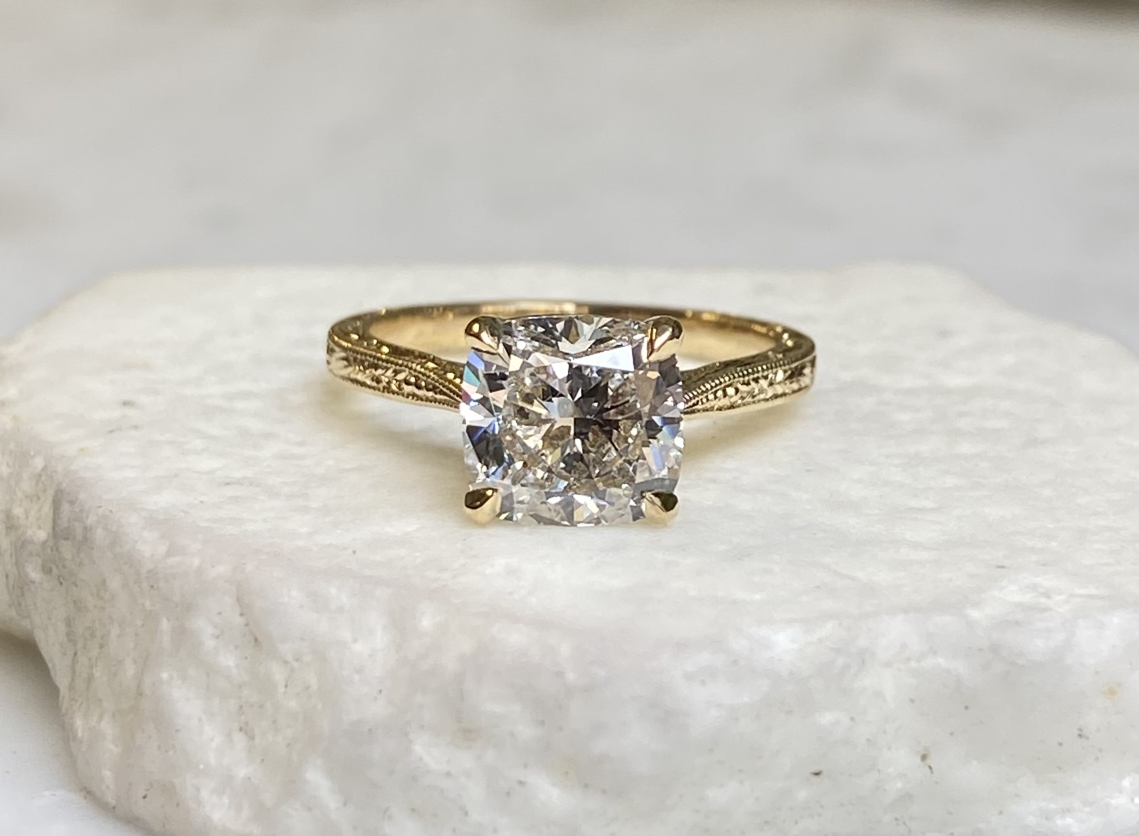 Hand-engraved cushion diamond solitaire with wheat leaf scrollwork milgrain band in yellow gold — Bear Goldsmithing Toronto
