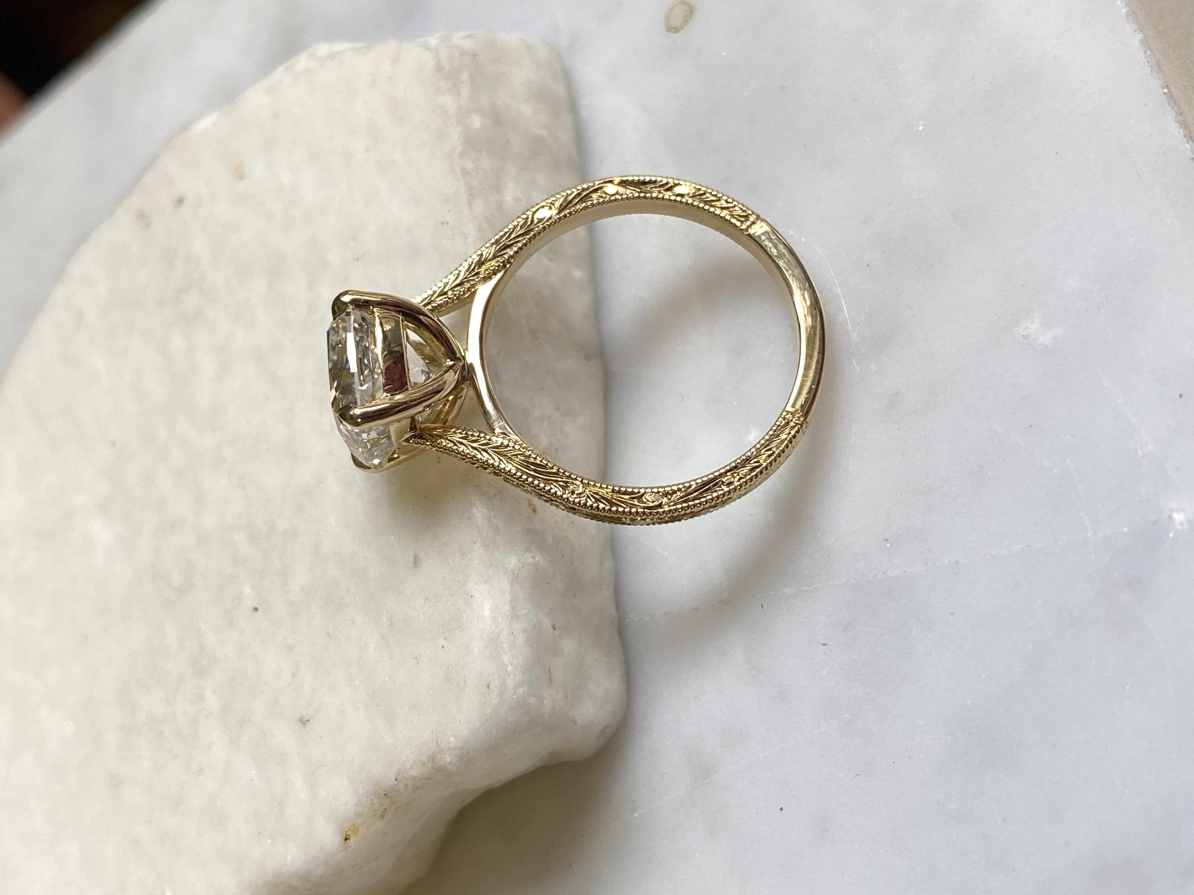 Cushion diamond solitaire side profile showing full wheat leaf engraving around the band — Bear Goldsmithing Toronto