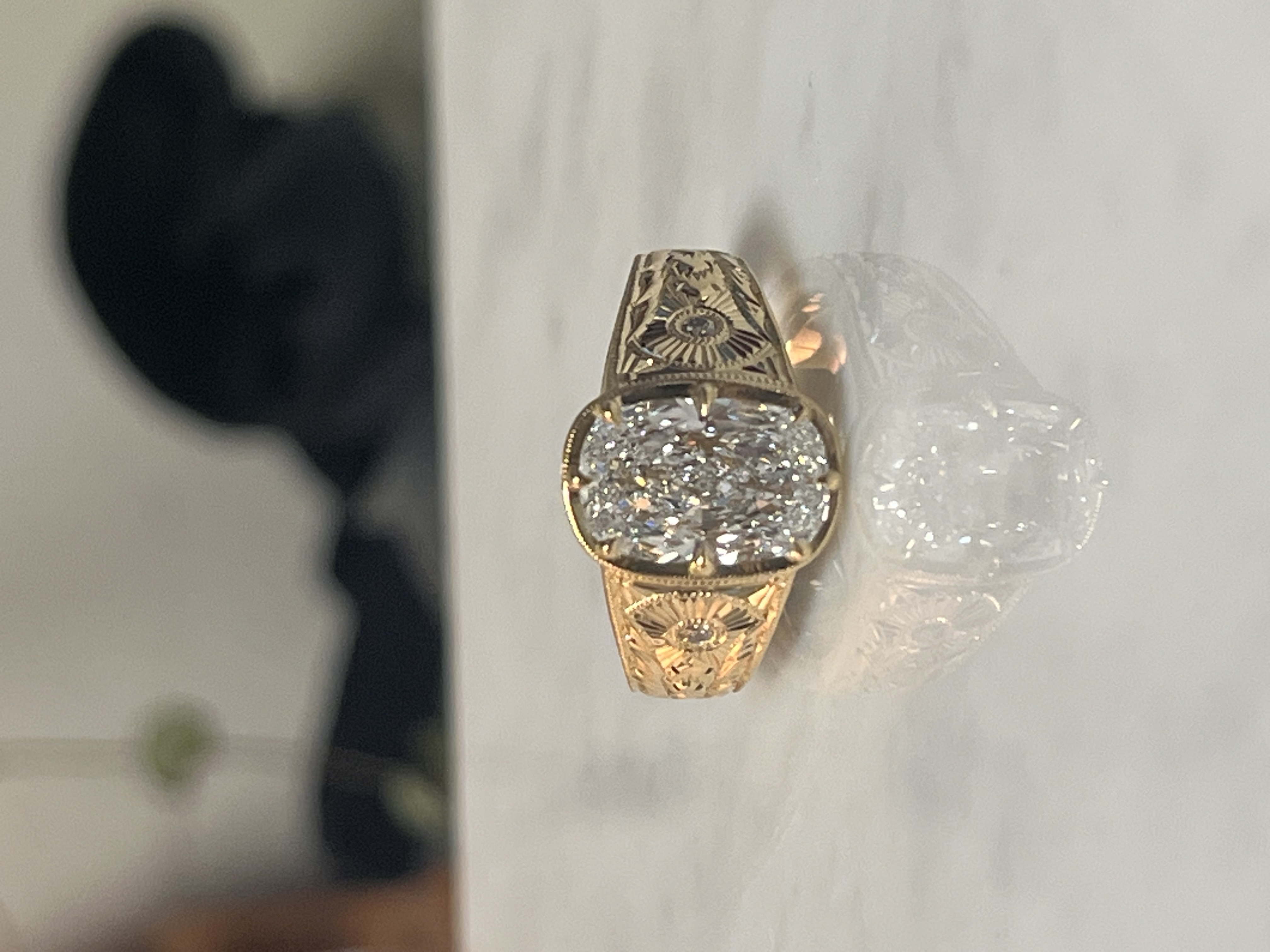 2.77ct cushion diamond engagement ring with sunburst and floral hand-engraving in yellow gold