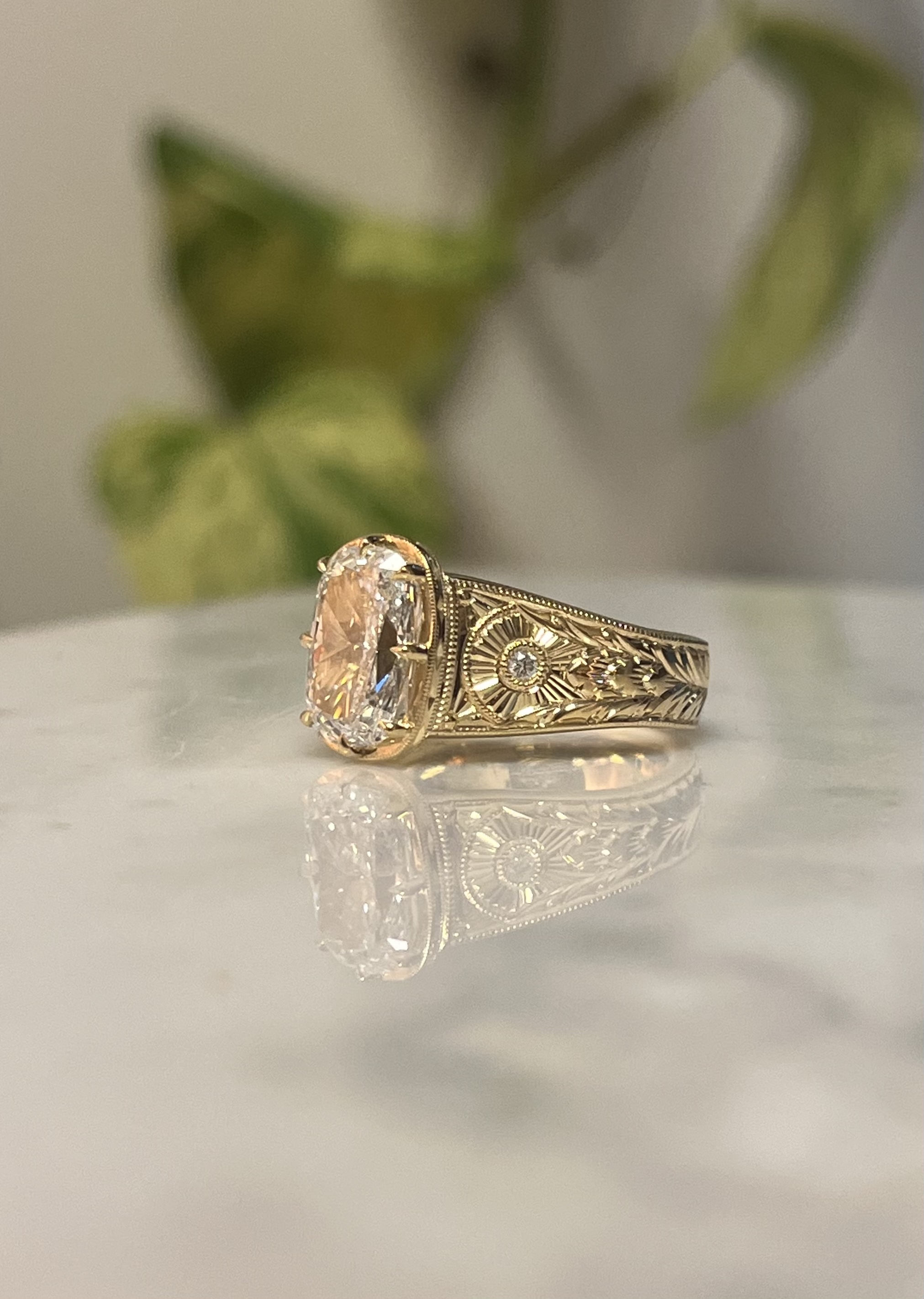 Floral vines and sunburst hand-engraving detail on yellow gold engagement ring band — Bear Goldsmithing