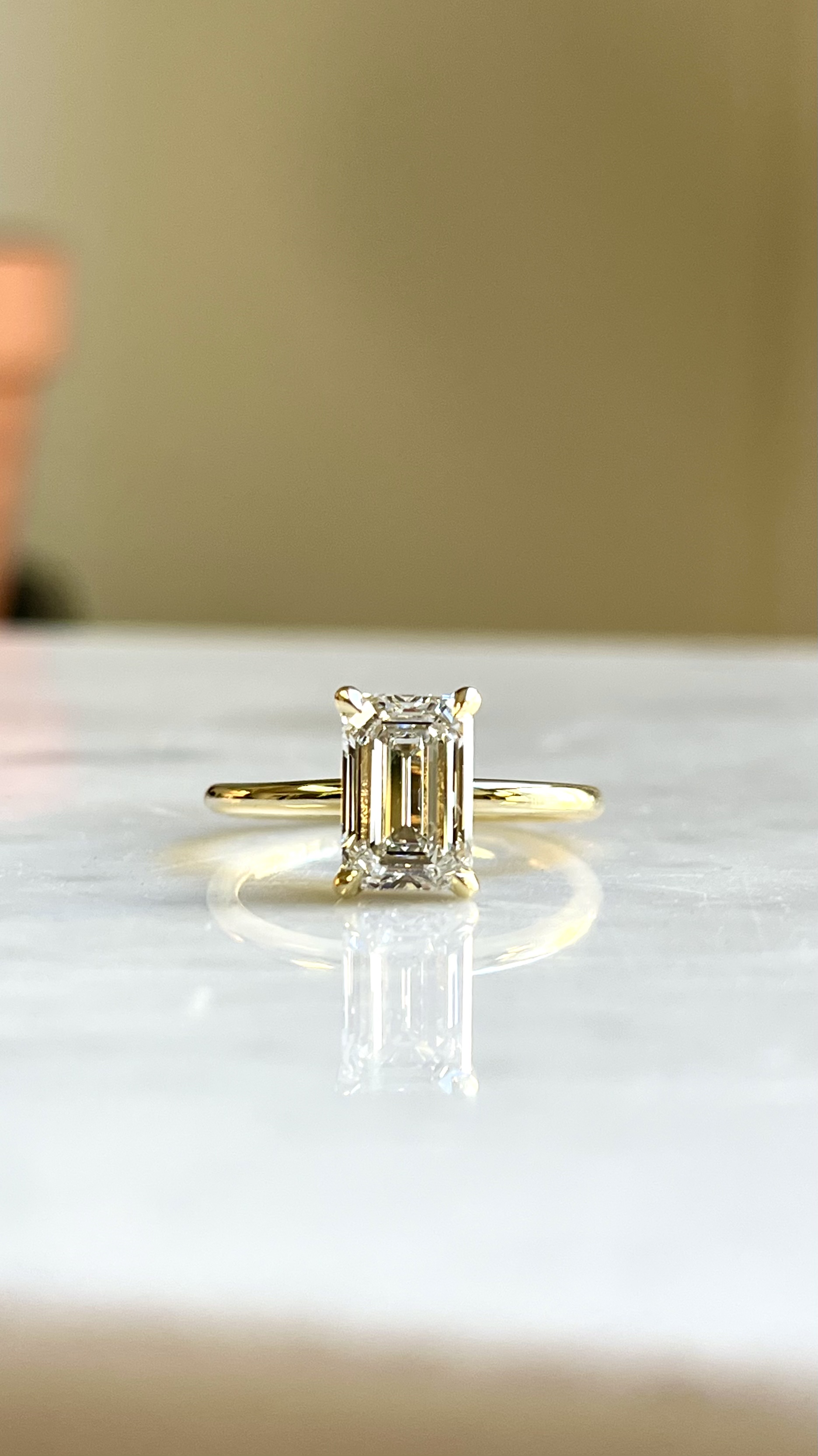 Emerald cut diamond solitaire engagement ring in yellow gold — Toronto goldsmith