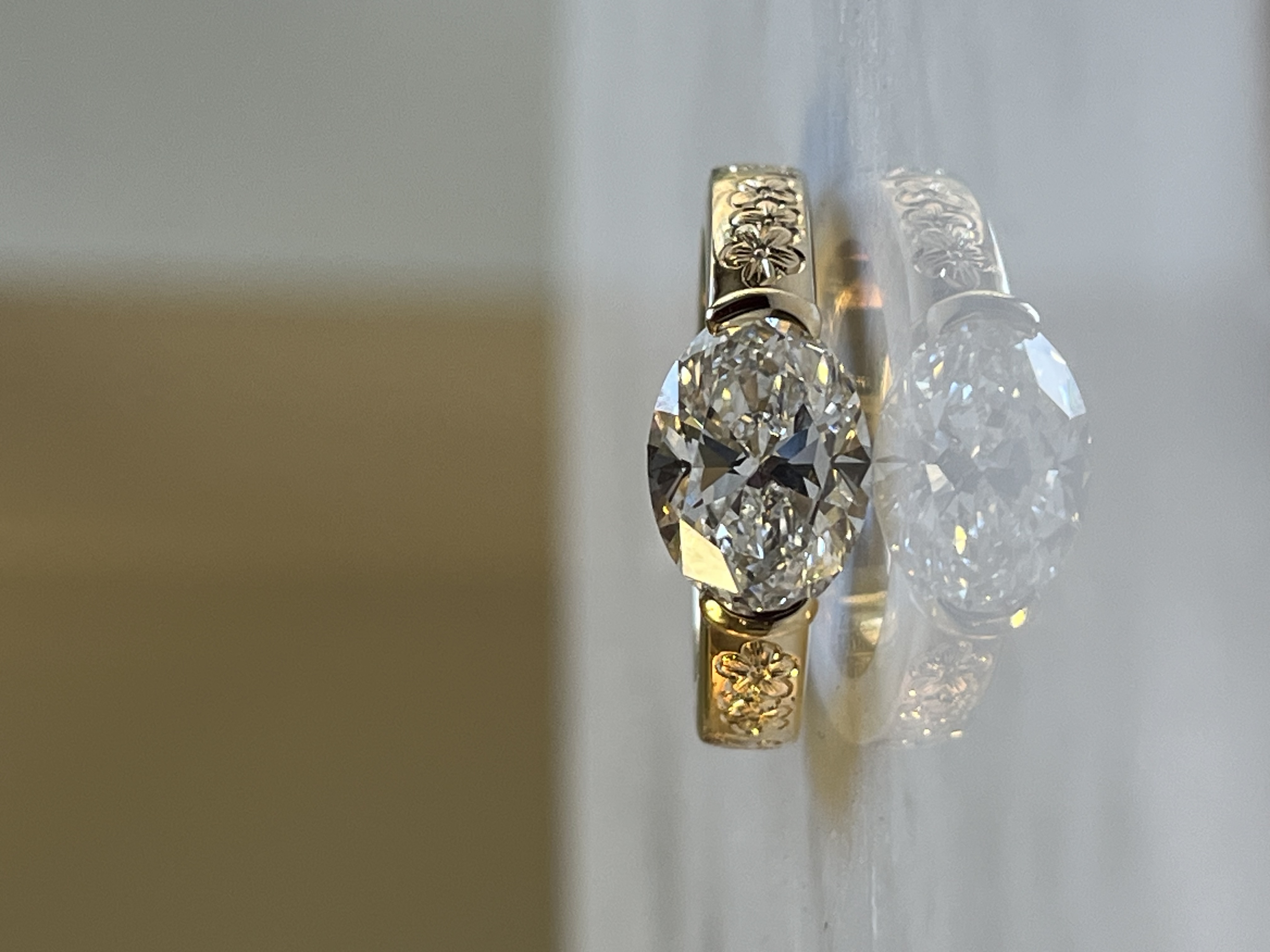 Top view of floral hand-engraved oval diamond ring — bespoke engagement ring Toronto