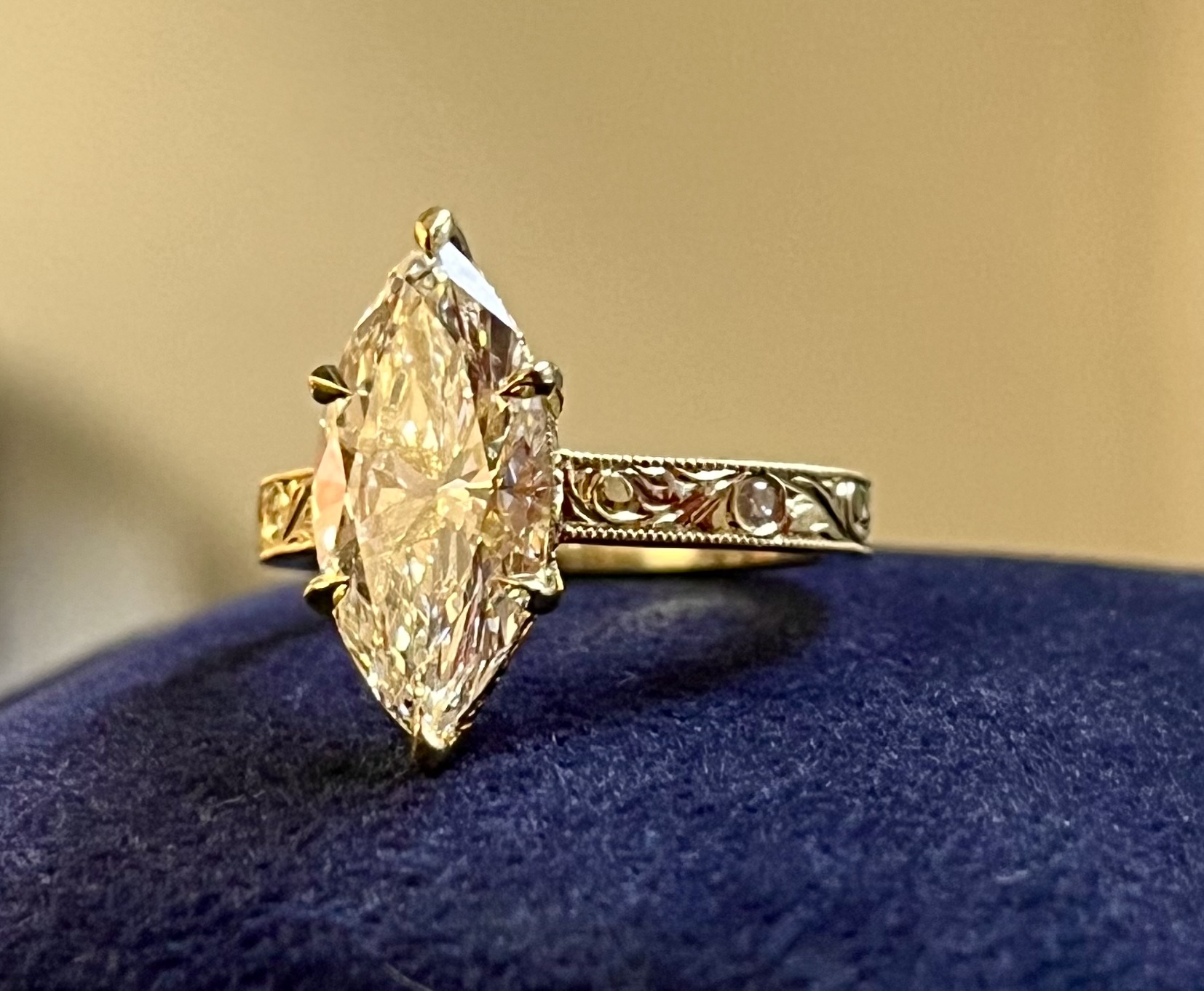 Marquise diamond solitaire yellow gold hand-engraved scrollwork band flush-set accent diamonds engraved gallery rail milgrain edge — Bear Goldsmithing Toronto