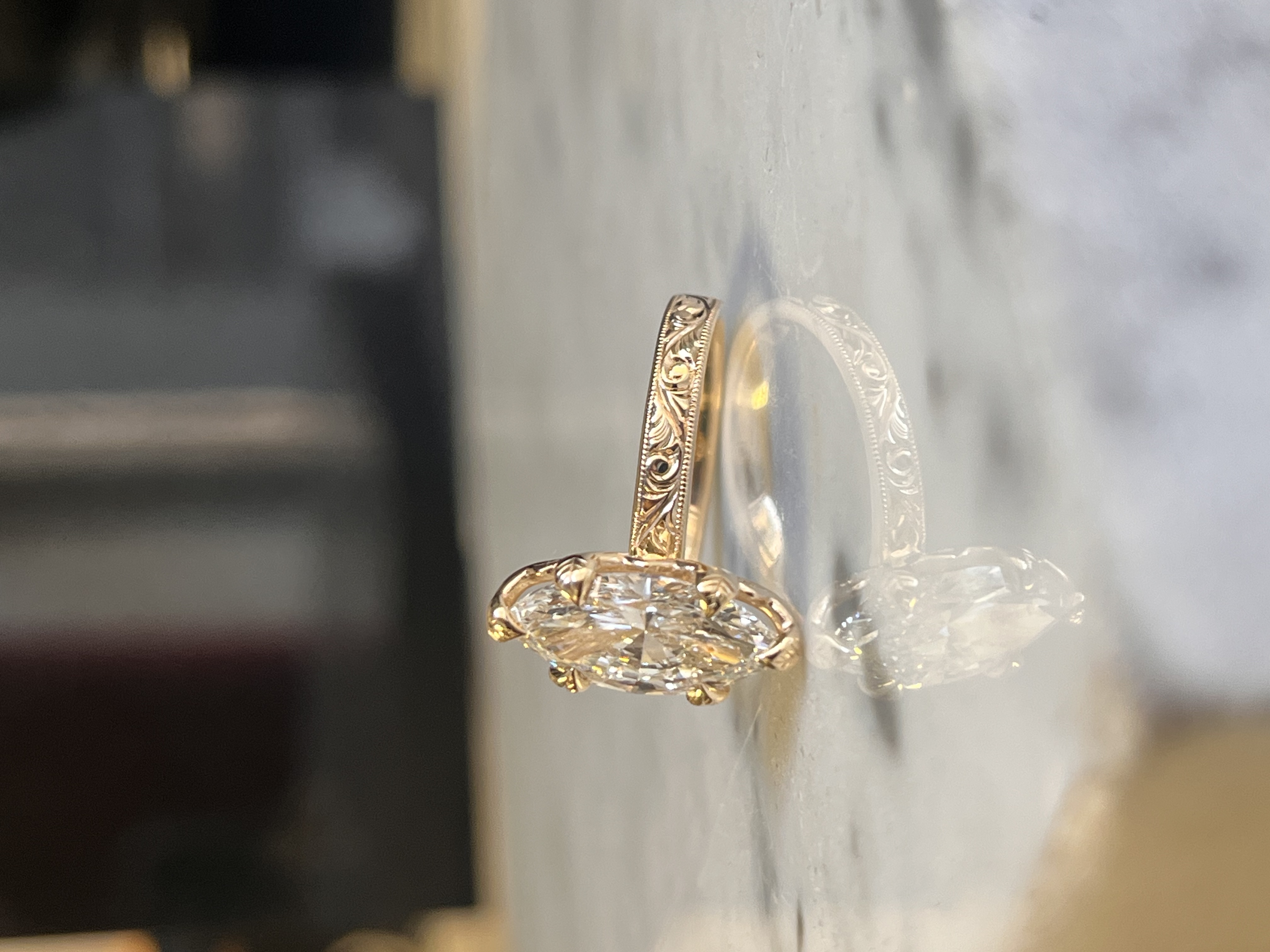 Hand-engraved scrollwork marquise solitaire engagement ring with leaf-cut claws in rose gold — Bear Goldsmithing Toronto