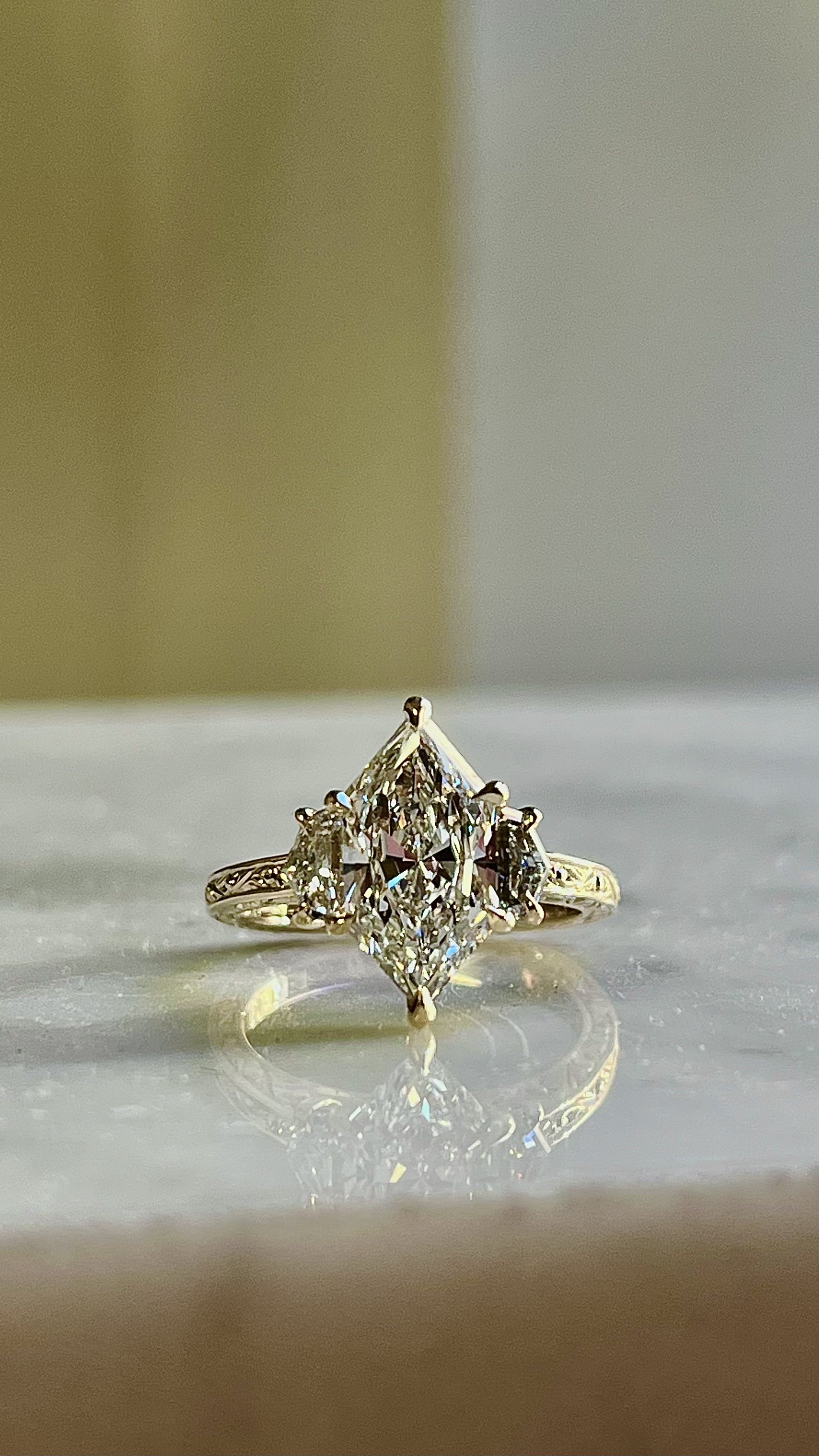 Marquise diamond three-stone engagement ring with trillion side stones — custom ring Toronto