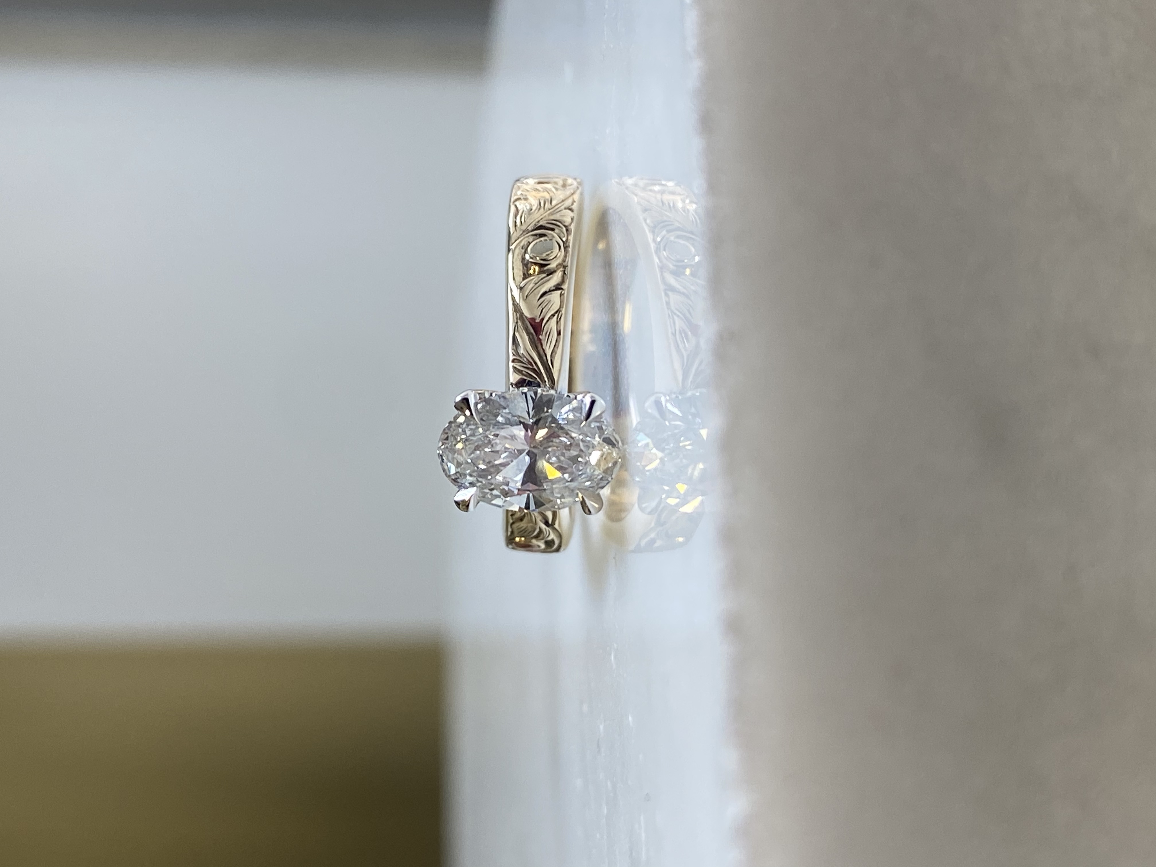 Oval solitaire deep hand-engraved wide taper engagement ring with hidden halo accent diamonds in yellow gold — Bear Goldsmithing Toronto