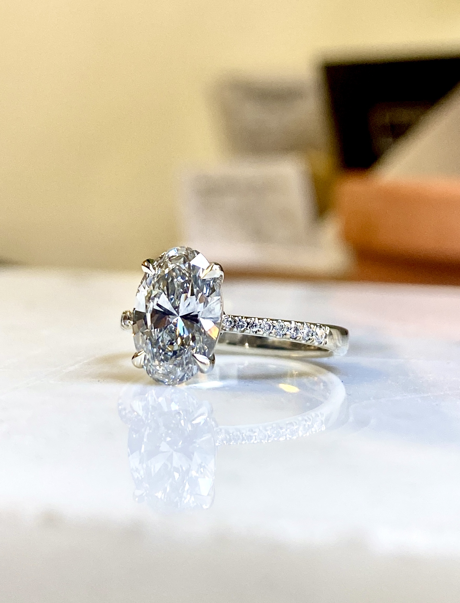 18k white gold oval diamond engagement ring with tasteful side diamonds pave band — Bear Goldsmithing Toronto