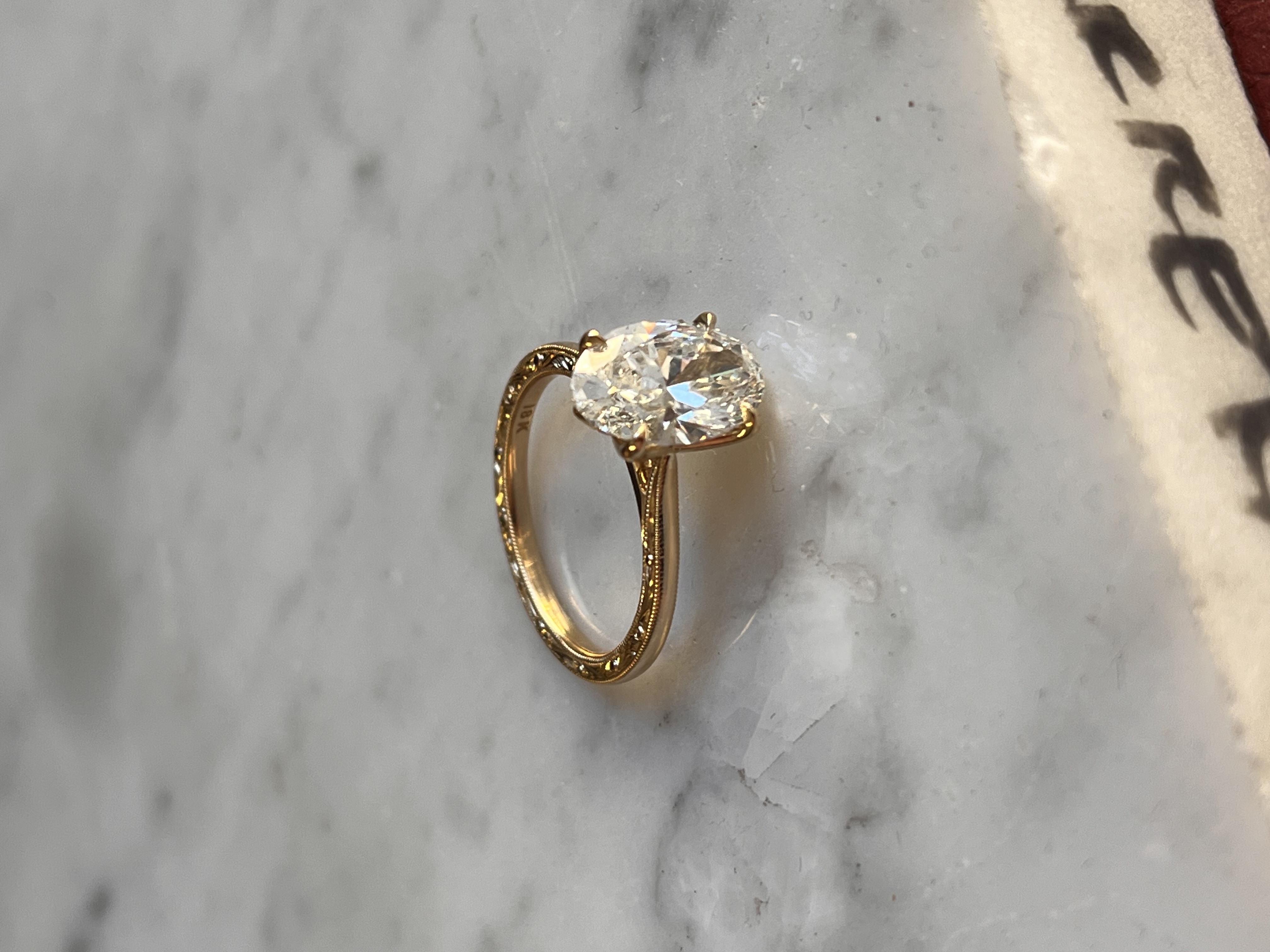 Classic scrollwork oval diamond solitaire engagement ring — hand-engraved in Toronto