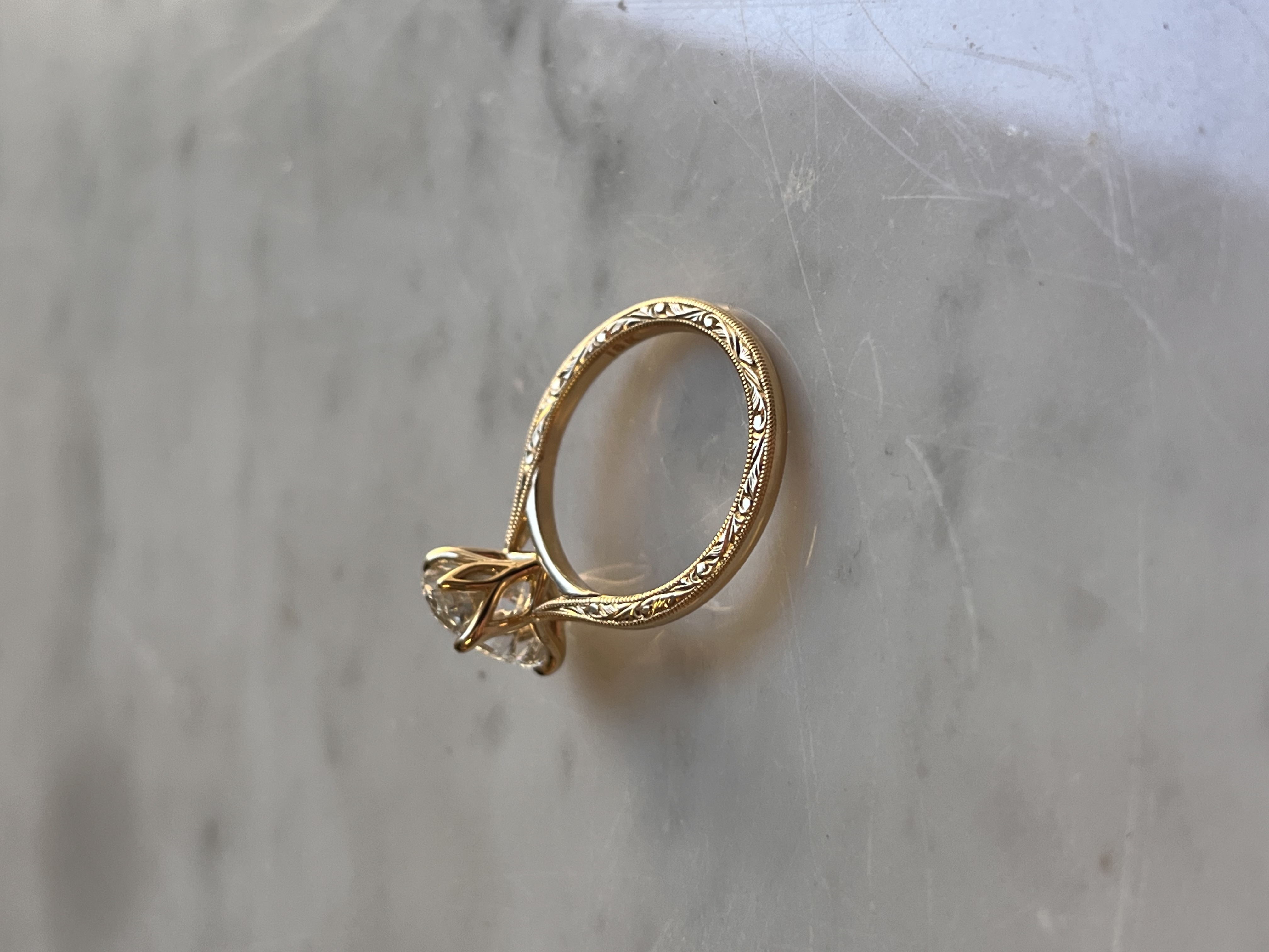 Hand-engraved scrollwork band detail on oval diamond engagement ring — Bear Goldsmithing Toronto