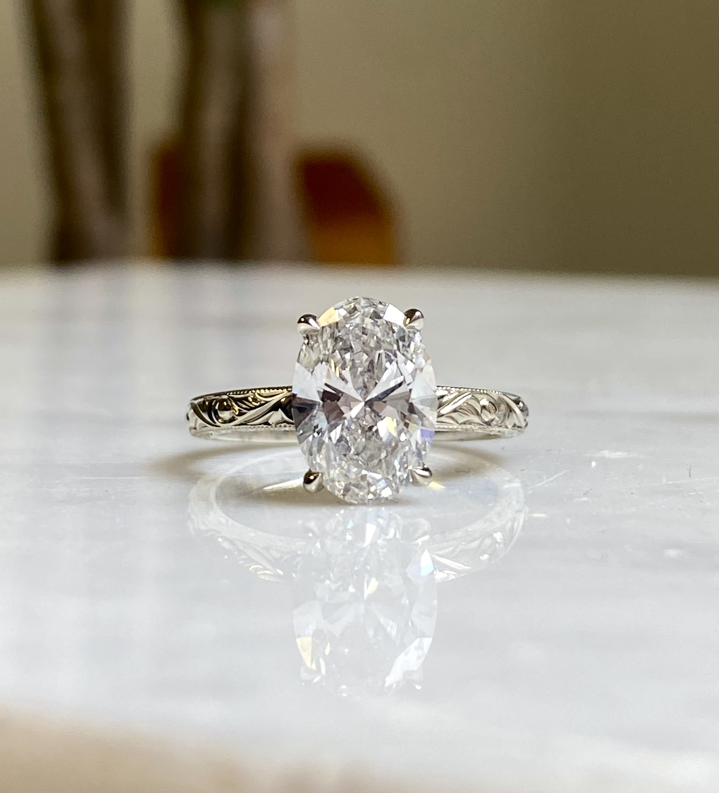 Oval diamond solitaire white gold rounded shank with scrollwork engraving milgrain edge engagement ring — Bear Goldsmithing Toronto