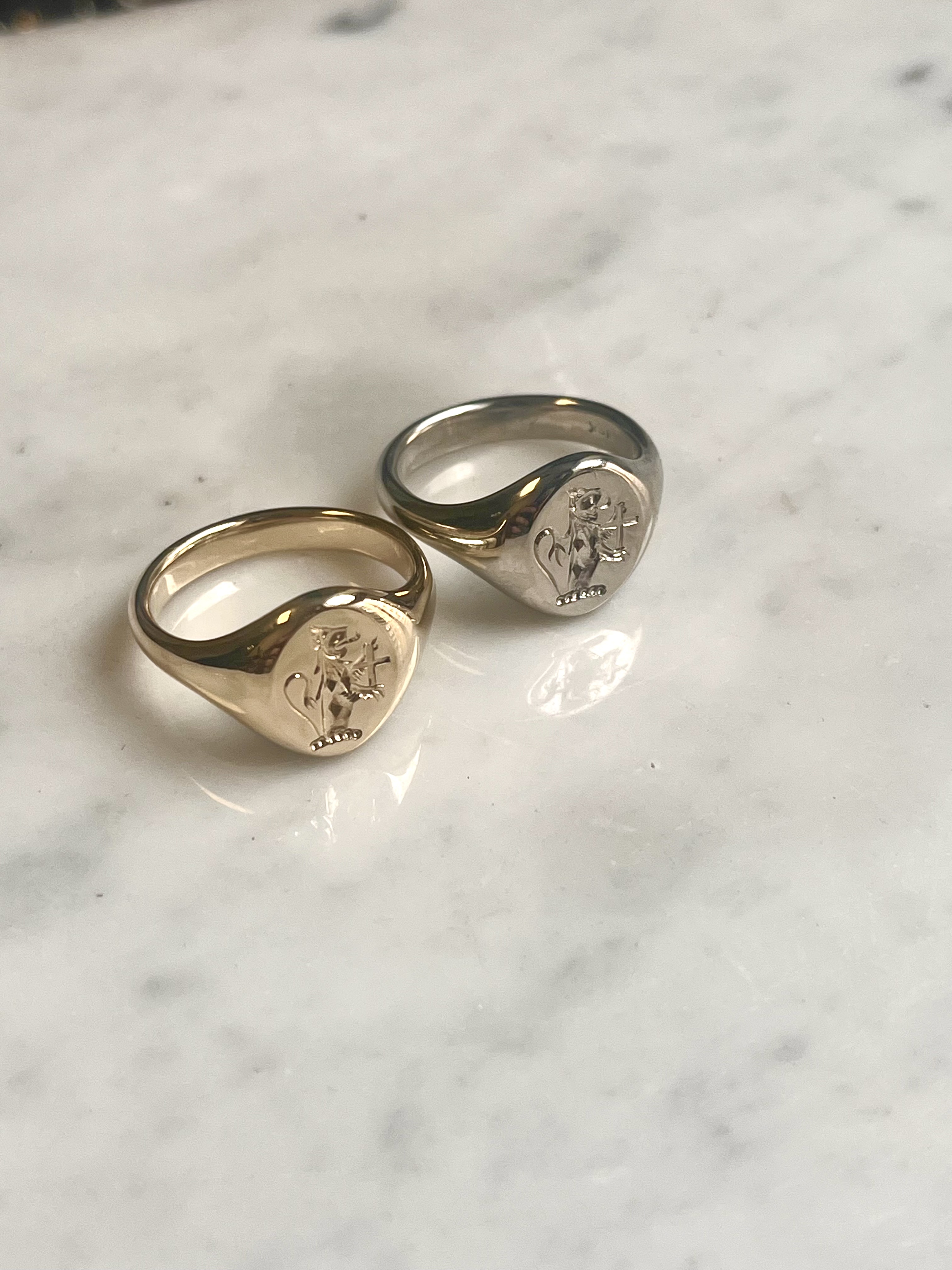 Matching Austin family crest signet rings in 14k yellow and 19k white gold — heraldic engraving Toronto